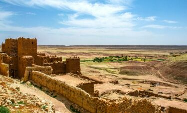 Explore the majestic ruins of a fortress amidst the arid landscapes of Zagora, Morocco.